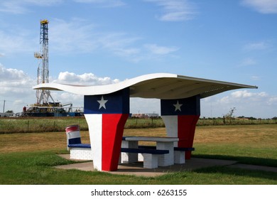 A Picnic Table At A Rest Stop In Texas With An Oil Rig In The Background.