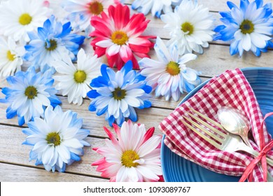 Picnic Table Setting In Red White And Blue Colors For July 4th Celebration On Wood Board Background Table With Room Or Space For Copy, Text Or Your Words.  A Horizontal Flatlay Photo From Above View.