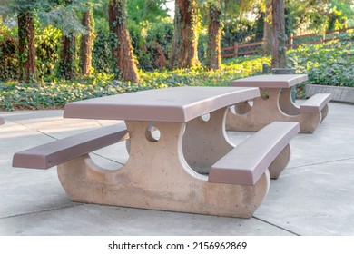 Picnic table with two seats on a concrete pavement at Japanese Friends Garden in San Jose, CA - Powered by Shutterstock