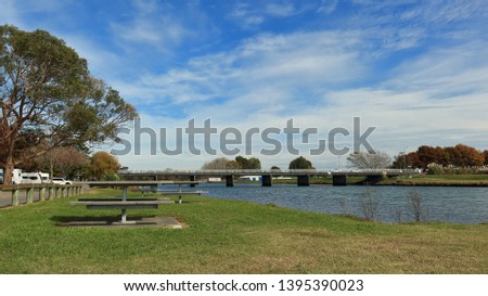 Picnic tables next to the Clive River and bridge, in Clive, Hawke's Bay, NZ