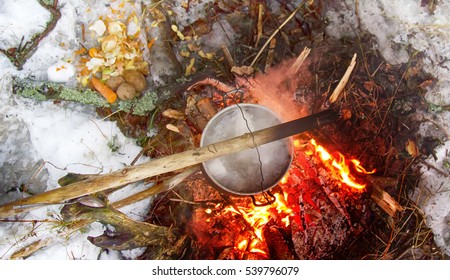 Picnic In Winter On Nature: Bonfire And Cooking In Campaign, Field Kitchen Of Hiker Food, Dilettante Hiking Outfit