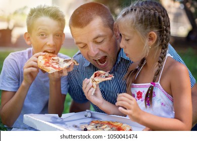 Picnic.Father with children eating pizza - Powered by Shutterstock