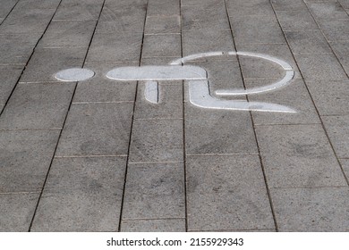 pictogram of a wheelchair on the street, marking a parking space for a wheelchair user