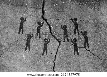 Pictograms representing the conflict are painted on the cracked concrete.