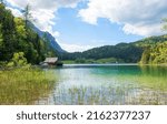 pictorial lake Lautersee at springtime, boathouse and view to Wetterstein mountain, landscape near Mittenwald bavaria