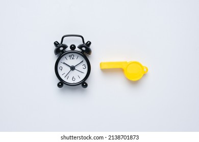 A Picture Of Alarm Clock And Whistle On White Background. Extra Time Concept