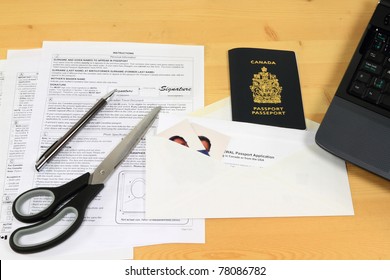 Picture of all objects (application form, passport pictures, mail envelope and expired passport) used to apply for Canadian passport renewal by mail.