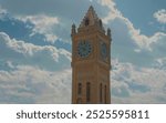 A picture of the ancient Erbil clock in the middle of the city, in front of the fountain and the old castle in the Kurdistan region of Iraq