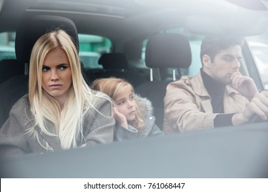 Picture Of Angry Displeased Young Family Sitting In Car After Quarrel. Looking Aside.