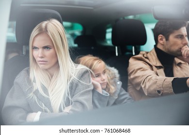 Picture Of Angry Displeased Young Family Sitting In Car After Quarrel. Looking Aside.