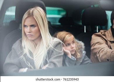 Picture Of Angry Displeased Young Family Sitting In Car After Quarrel. Looking Aside.