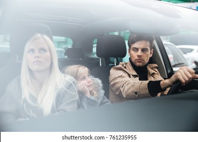 Picture Of Angry Displeased Young Family Sitting In Car After Quarrel. Looking Aside.