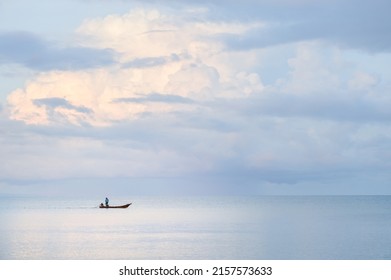 Picture of Asian fishermen on a wooden boat Thai fishermen catch fish in the sea.