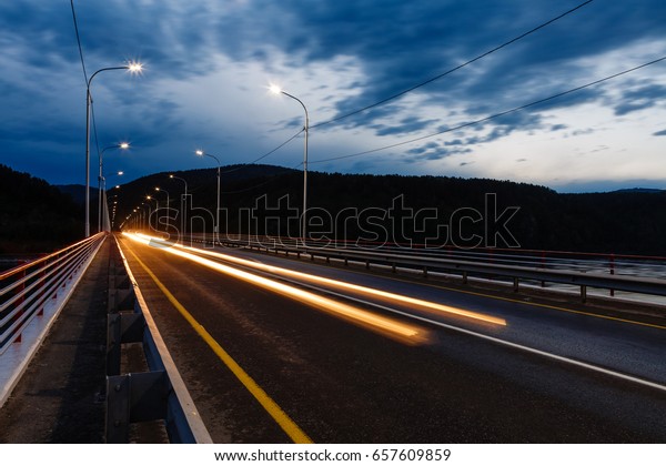 Picture of the automobile bridge at night, with\
lamps, on long\
endurance
