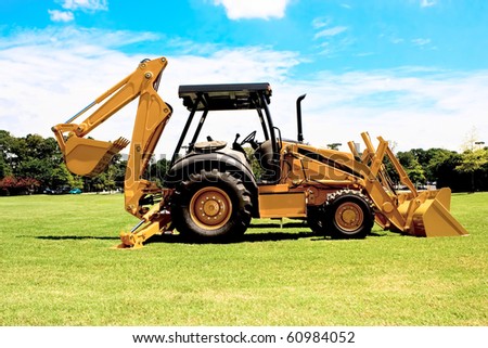Picture of a back-hoe ready to start moving dirt at a construction site.