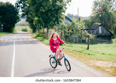 Picture Of A Beautiful Chubby Girl In Red Dress Rides An Old Bike In Village