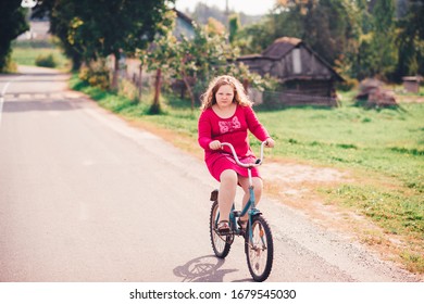 Picture Of A Beautiful Chubby Girl In Red Dress Rides An Old Bike In Village