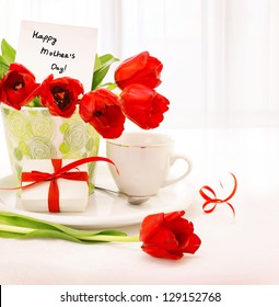 Picture Of Beautiful Tulips Pot With Gift Box And Cup Of Tea On The Table At Home, Breakfast For Mommy, Happy Mothers Day, Morning Drink, Romantic Still Life, Indoor Decorations, Fresh Red Flowers