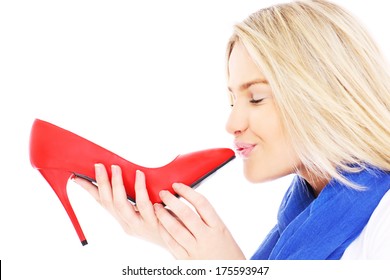 A picture of a beautiful woman kissing her red heels over white background - Powered by Shutterstock