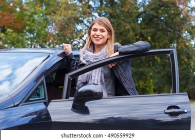 Picture Of A Beautiful Young Women Being Proud Of Her New Car