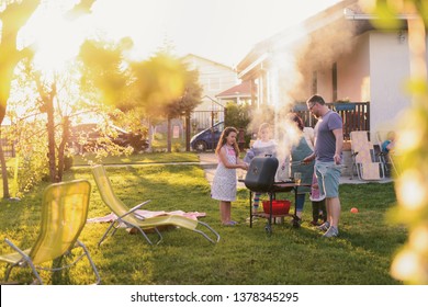 Picture Of Big Happy Family Making Barbeque In Their Backyard. Family Time On Sunny Summer Day.