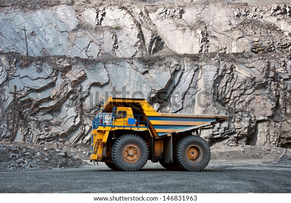 A\
picture of a big yellow mining truck at work\
site