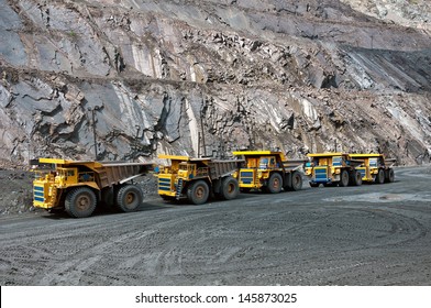 A Picture Of A Big Yellow Mining Trucks At Work Site