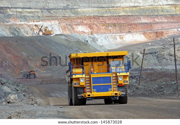 A
picture of a big yellow mining trucks at work
site