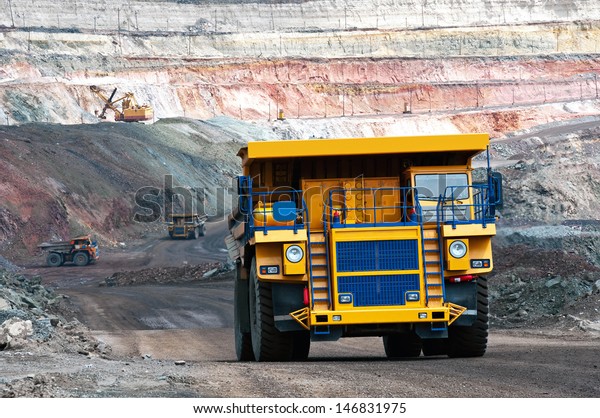 A\
picture of a big yellow mining trucks at work\
site