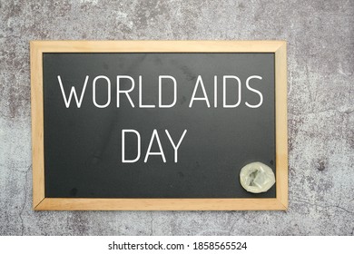 A picture of blackboard written World AIDS Day and condom insight. - Powered by Shutterstock