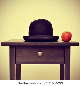 Picture Of A Bowler Hat And An Apple On A Bureau, Homage To Rene Magritte Painting The Son Of Man, With A Retro Effect