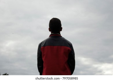a picture of a boy looking at the clouds 