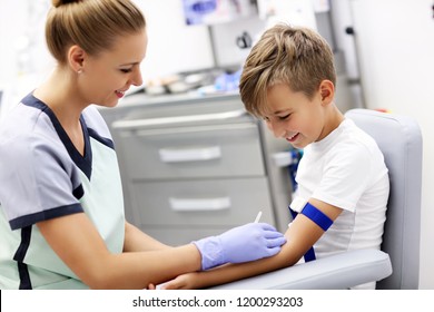 Picture of brave little boy having blood collection for tests