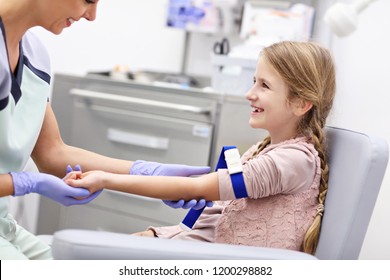 Picture of brave little girl having blood collection for tests