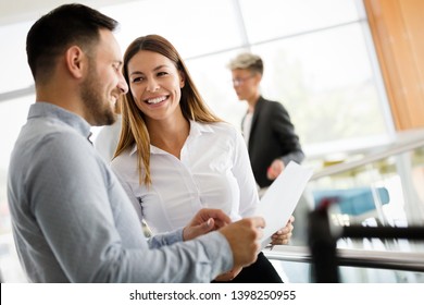 Picture Of Business Colleagues Talking In Office