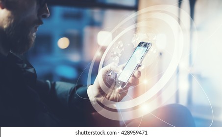 Picture businessman relaxing modern loft office.Man sitting in chair at night.Using contemporary smartphone,blurred background. Digital Connections World Wide Interfaces.Horizontal,film effect - Powered by Shutterstock