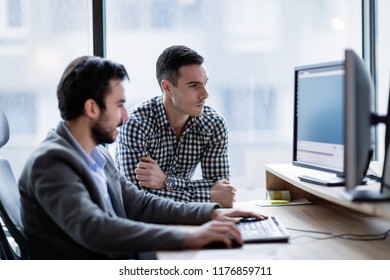 Picture of businesspeople working on computer together - Shutterstock ID 1176859711