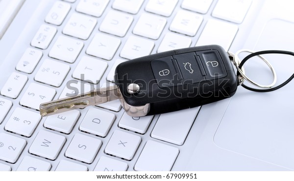 Picture of car key on\
keyboard