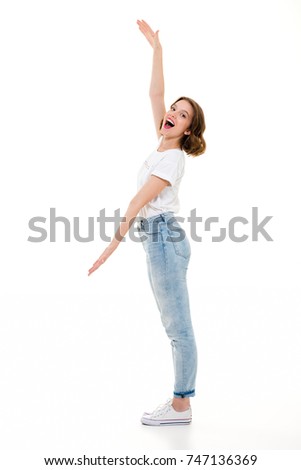 Picture of cheerful pretty caucasian lady standing isolated. Looking camera gesturing with hands showing copyspace.
