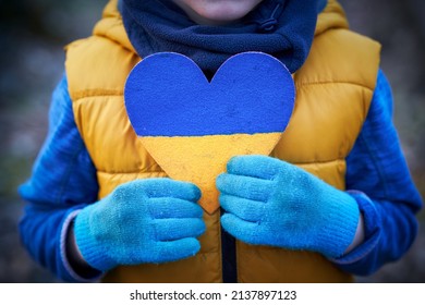 Picture of a child with a lot of love and peaceful message holding heart - Powered by Shutterstock