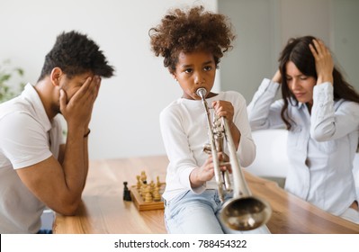 Picture of child making noise by playing trumpet