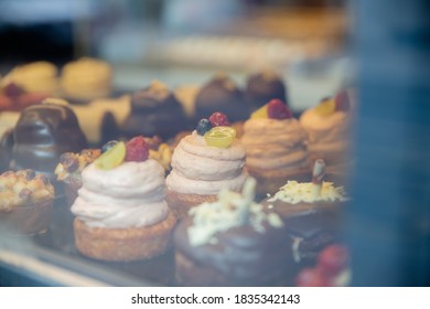 Picture of Chocolate and Cream Muffins and Cupcakes Through the glass of a Window from a bakery - Shutterstock ID 1835342143