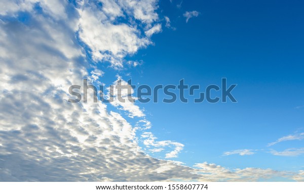 The picture is clearly divided in half from the\
clouds that cover the dense sun on the left bank. But the right\
side is clear, without\
clouds