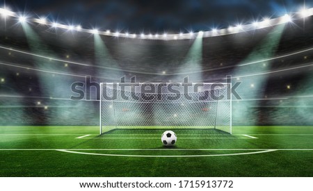 The picture is a composition, not a real stadium------ Ball on the green field at soccer stadium. ready for game in fro