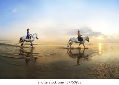 Picture a couple in love, which is galloping on a horse of the sea at sunset - Powered by Shutterstock