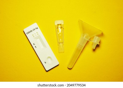 A Picture Of Covid-19 Antigen Saliva Rapid Self Test Kit On Yellow Background . 