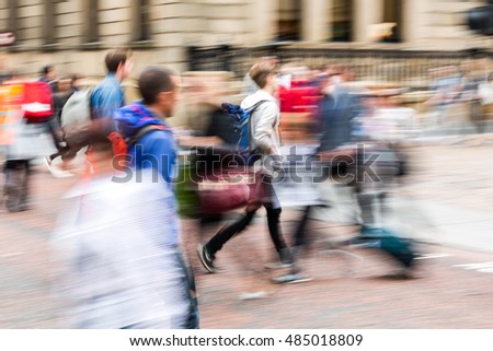 picture with creative zoom effect made by camera of a people crowd crossing a city street