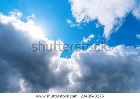 Picture of cumulus clouds with sun rays and blue sky. Picturesque skyscape nature. 