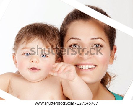 Picture of cute brunette woman holding her cute little son isolated on white background, closeup portrait of attractive female with sweet infant in white frame, happy parenthood concept