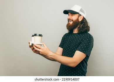 A Picture Of A Delivery Guy Delivering Two Cups Of Coffee To Someone